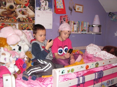 Two children listening to their MP3 players