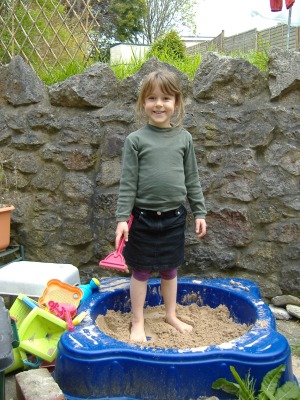 Paddling in the sandpit.